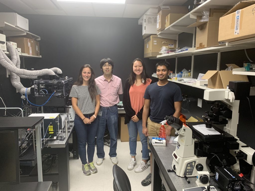 4 people in microscope room